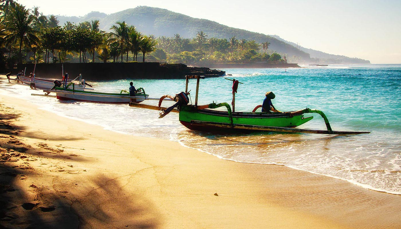 Beach with men in small fishing boats