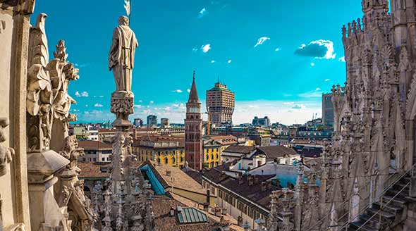 View from Duomo over city rooftops with blue sky